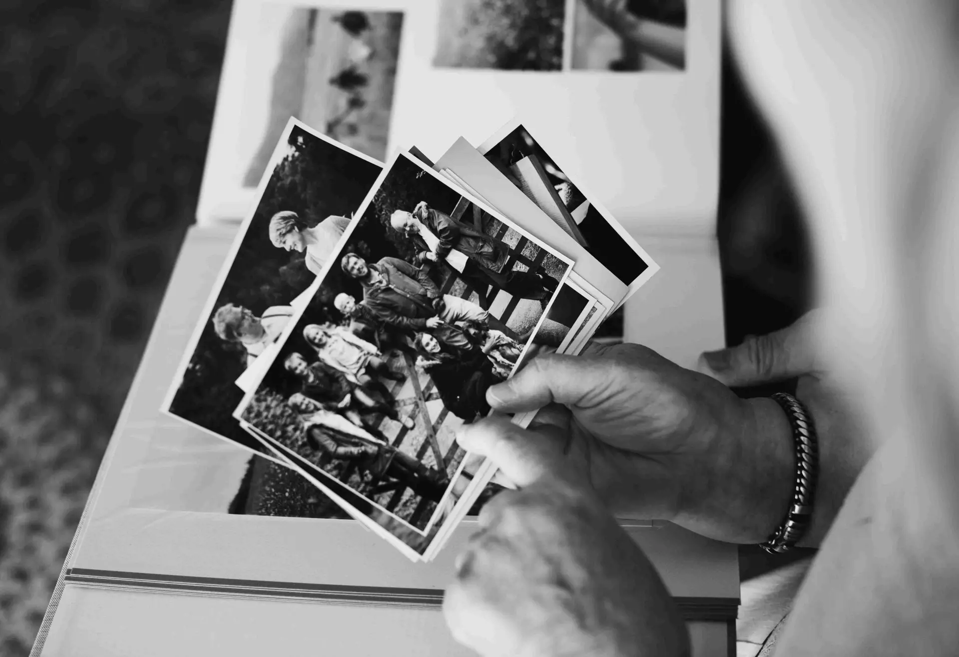 senior-couple-looking-at-family-photo-album-2023-11-27-05-20-17-utc